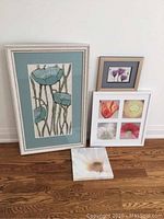 Full view of all art pieces showing variety in size and framing styles