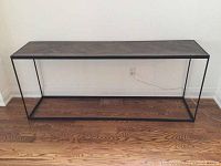 Full front view of console table against wall on hardwood floor