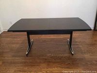 Front view of table in default configuration showing top surface and pedestal base