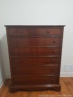 Front elevation of six-drawer highboy in medium brown finish