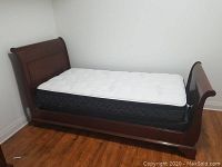 Full left-side view of assembled bed frame and mattress