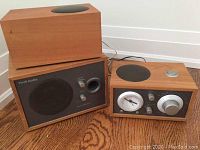 Overview of clock radio, passive speaker and powered subwoofer in cherry wood finish with cables.