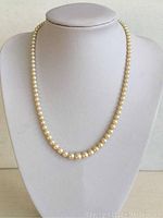 Necklace displayed on bust showing overall length and graduation of pearls