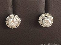 Front view of both earrings with jackets attached on dark background