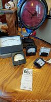 Photo showing the entire set on a wooden table including the clock and five gauges of various sizes and shapes.