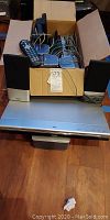 Full lot showing DVD player, speakers in box, remote on top
