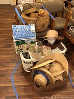Wicker bed tray loaded with various baskets, sun hats, and a decorative box