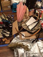 Group photo showing multiple purses, umbrellas, and a portion of the coat