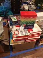 Wide view of many Adobe Type Library boxes stacked along with other boxed items and electronics.