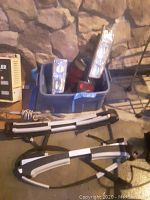 Overall view of the lot showing multiple car lights in a blue container and Thule car mount placed on the floor.