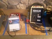 Overview image showing three chargers, Kohler battery charger on right, two Sears fence chargers on left.