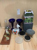 Full lot of assorted candle holders and decor items including Party Lite tin house, glass candle holders, llama planter, painted vase, Willow Tree figurine, and small animal candle holders on tray.