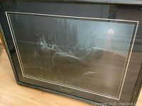 Framed limited edition print with pack of wolves under moonlight, showing full artwork and frame.