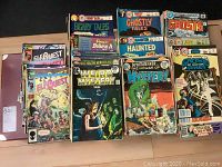 Collection of comics including ElfQuest, Ghostly Tales, Haunted, Weird Mystery Tales, and Doctor Graves with colorful covers and vintage style.