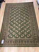 Full view of the Lisbon Collection area carpet laid flat on the floor showing overall pattern and borders.