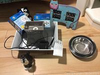Full view of all items: ceramic fountain with power cord, two boxes of replacement filters, two stainless steel bowls, cat picture frame, two cat-shaped salt and pepper shakers.