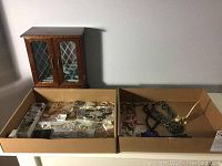Wooden jewelry box and two boxes with costume jewelry on table