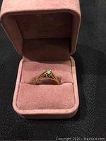 Ring displayed in pink jewelry box showing overall appearance
