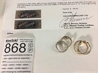 Certificate from Calgary Jewellery Ltd dated July 14, 1994 listing appraisal values for the gentleman’s 14K and ladies’ 10K two-tone interlocking wedding rings, each set with ten brilliant cut diamonds, 0.18ct total weight