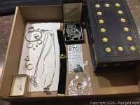 Box contains assorted necklaces, rings, earrings, Asian brooch, choker bracelet, and wooden jewelry box.
