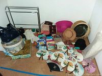 Wide view of fans, hats, purses, scarves, shoes and umbrella arranged on floor