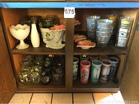 Full cabinet shot showing top and bottom shelves with all items