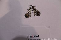 Photo showing small sterling silver earrings with tiger eye stones and a patina, earrings stamped 925 on the back