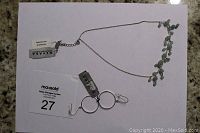 Full view of silver chain necklace with green aventurine stones and sterling silver hoop earrings with tags included.