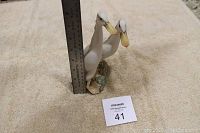 Porcelain duck figurine about 8 inches tall next to a ruler for scale