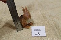 Porcelain bunny figurine next to a ruler showing approximately 5 inches in height.
