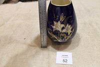 Photo showing the vase with ruler indicating approximately 10.5 inches tall, dark blue with gold floral pattern.