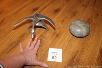 Photo of the pewter goose figurine next to soap stone trinket dish on wooden floor.