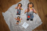 Three German Steiff Mecki hedgehog dolls of varying sizes placed on white tissue paper showing overall condition and size difference