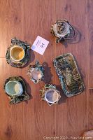 Top view of complete tea service set laid flat showing teapot, creamer, sugar bowl, cups with saucers, and serving platter.