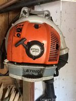 Front view of Stihl BR 550 backpack leaf blower hanging in shed