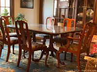 Full view of six chairs around dining table showing chair backs and legs