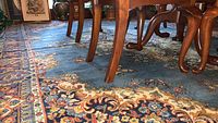 Blue rug under wooden dining table showing pattern and scale
