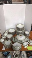 Full view of Thomas Bavaria china pieces stacked on table showing plates, bowls, cups, saucers, and serving dishes.