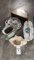 Photo of all porcelain decorative items in the lot including vases, trays, and a trinket box.