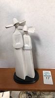 Front view of the tall Lladro nuns figurine on black base showing detail and size comparison