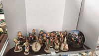 Group shot of approx. 19 Hummel figurines and one plate