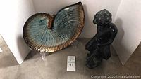 Photo of black mermaid sculpture and shell dish, showing size and details