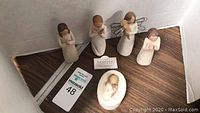 Six Willow Tree figurines including various angels and a baby, shown with maxsold lot tag 48