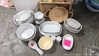 Overview of all Corning Ware and miscellaneous baking dishes including bowls, salt and pepper shakers, and spoon rest.