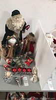 Photo showing the complete Victorian Santa lot including the Santas, candles,coasters, and ornaments on display.