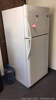 Full view of white Frigidaire refrigerator with top freezer.