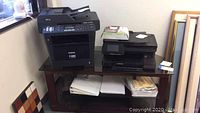 Wide view of corner table holding Brother fax machine and HP Photosmart 7525 printer