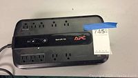 APC Back-UPS 750 battery backup and surge protector power outlets and control panel view.