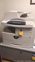 Front view of Xerox CopyCentre C multifunction office printer showing control panel and paper tray with a label attached.