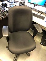 Black ergonomic office chair with cushioned seat and armrests